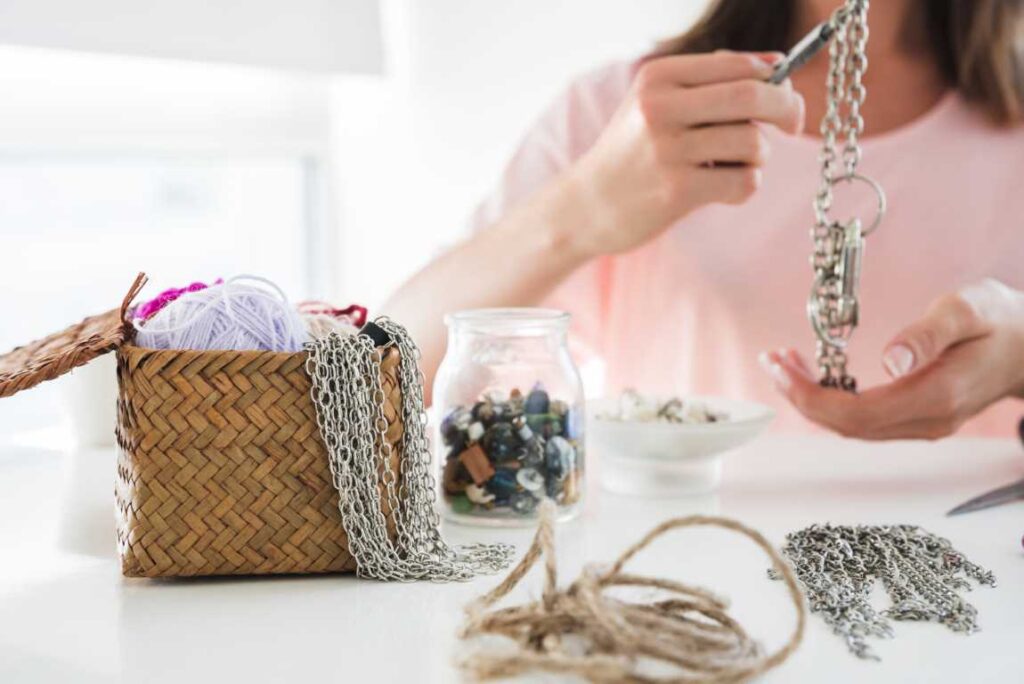 Close Up Woman Making Chain Bracelet With Beads White Desk Medium
